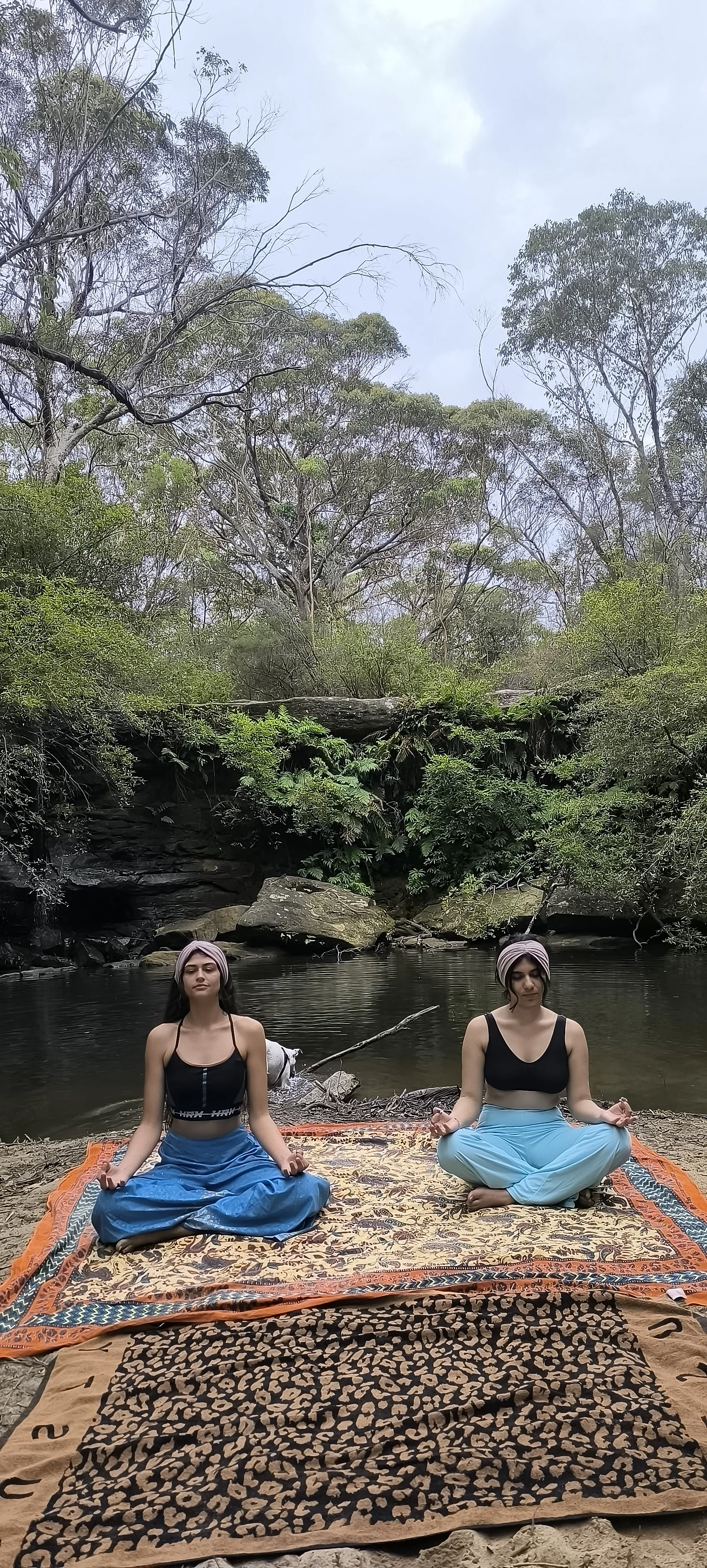 Instructor guiding yoga pose during private session