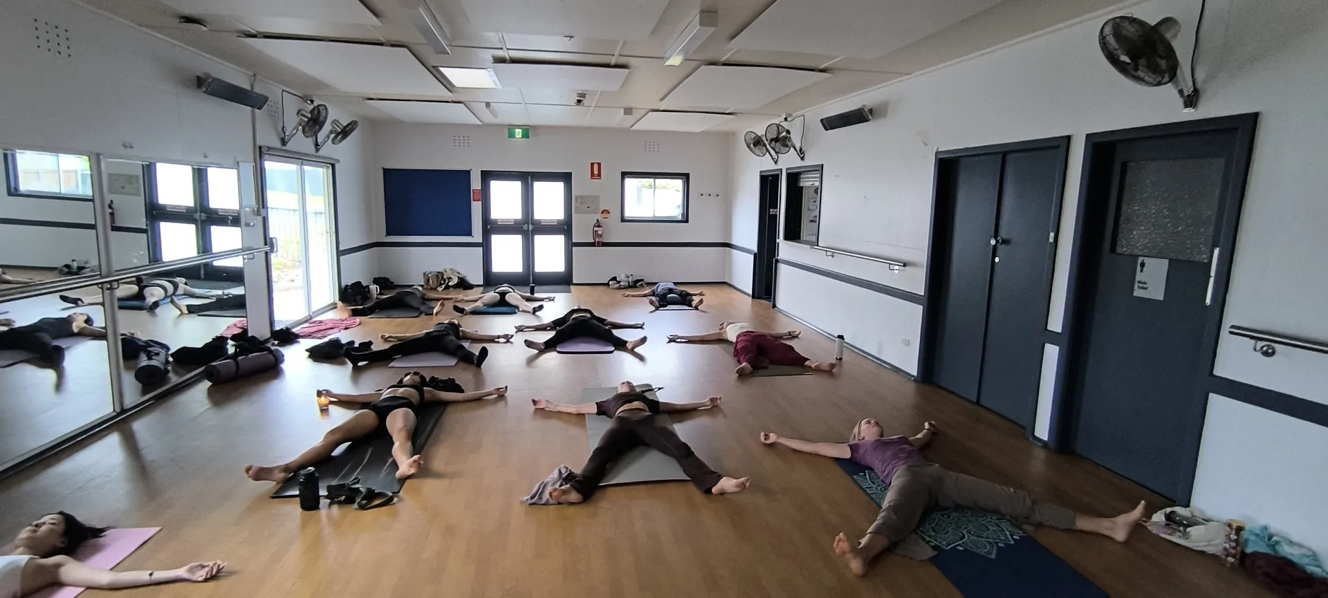Afternoon yoga workshop with women in supported bridge pose