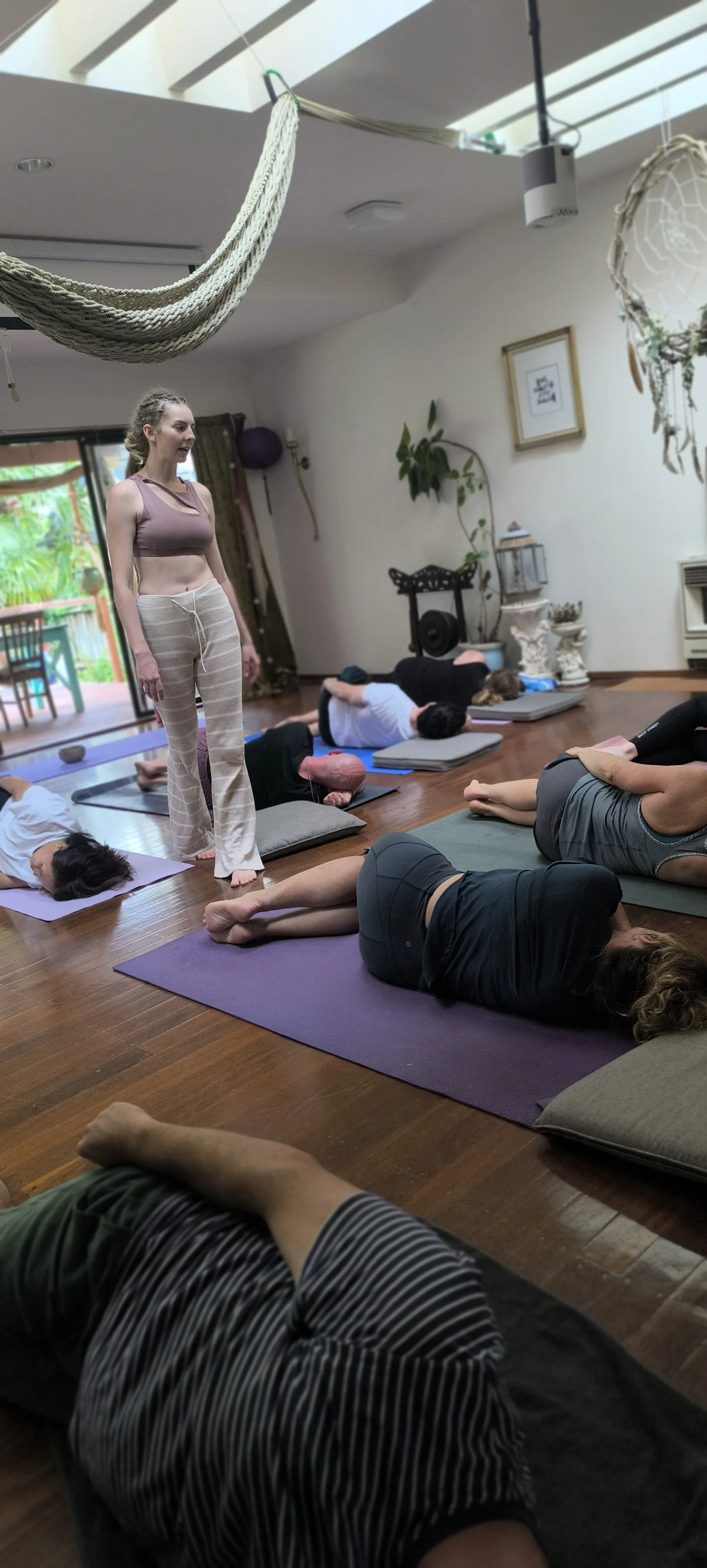 Yoga class in final savasana relaxation and integration