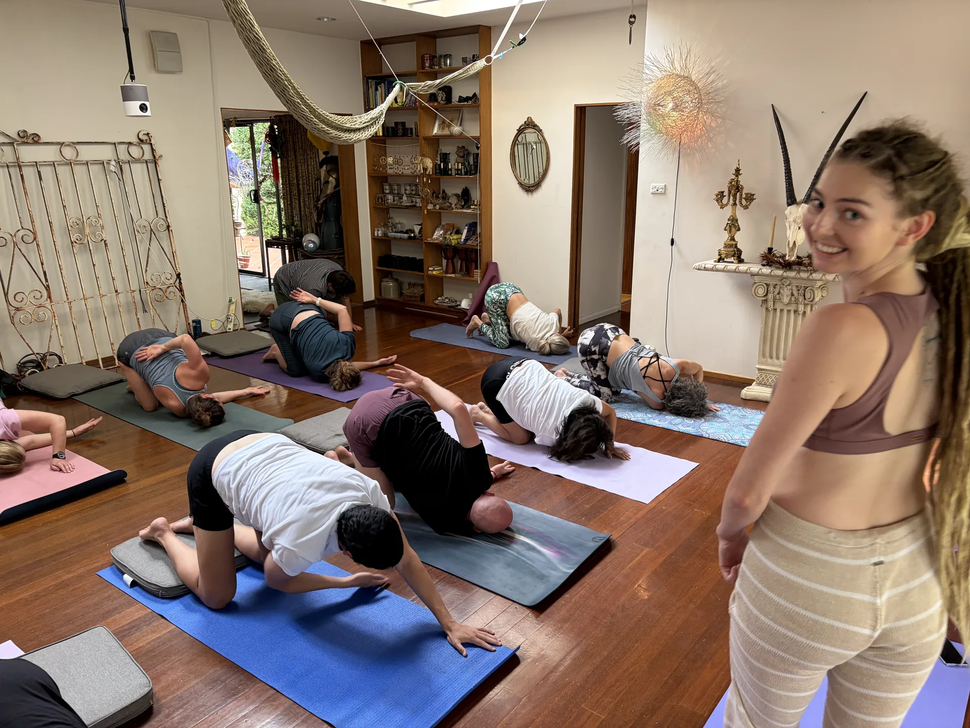 Women practicing yoga together in Mukti Yog group class